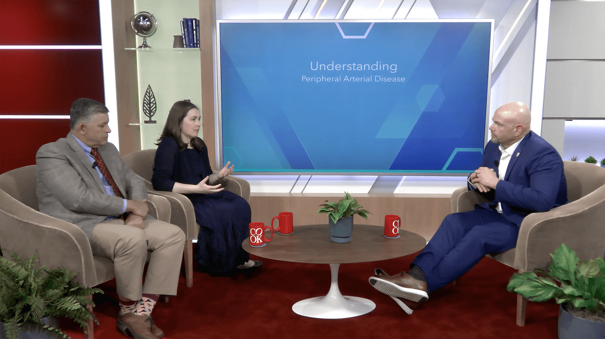Dr. Peña and Dr. McMackin sitting in a conference room with host Jeremy Andrews discussing managing PAD access complications.